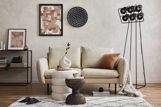 istock Modern elegnat living room interior design with sofa, console, mock up poster frame, lamp and stylish personal accessories. Copy space. Template.