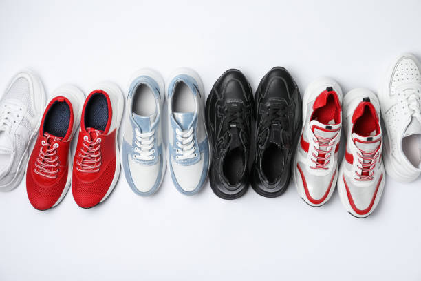 istock Many stylish sneakers on white background, top view 1360169054