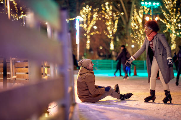 istock Lovely multiethnic couple enjoying ice skating 1360169414