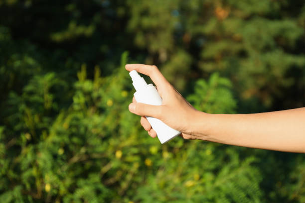 kobieta trzymająca środek odstraszający owady na zewnątrz, widok z bliska - insect repellant zdjęcia i obrazy z banku zdjęć