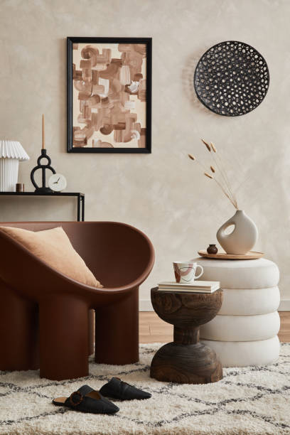istock Elegant living room interior composition with creative armchair, coffee table, pouf, mock up poster frame and creative design personal accessories. Copy space. Template.