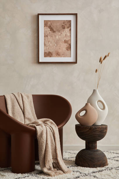 istock Elegant living room minimalist interior composition with creative armchair, coffee table, mock up poster frame and creative design personal accessories. Copy space. Template. 1360170202