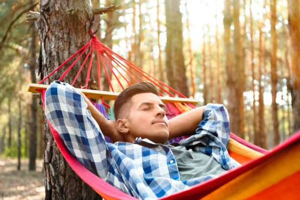 istock Man resting in hammock outdoors on summer day 1360170215