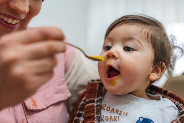 istock Mother is feeding her baby 1360170222