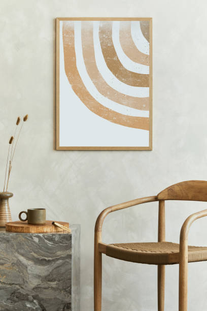 istock Stylish wabi-sabi dining room interior design with mock up poster frame, marble cube coffee table, armchair and bautiful personal accessories. Modern home decor. Template.