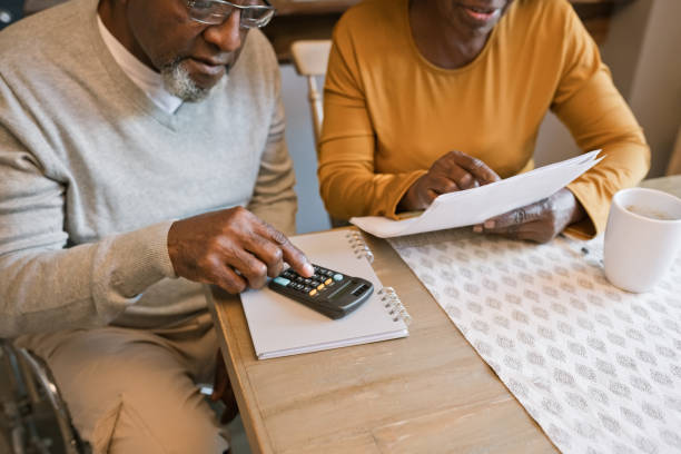 istock Senior couple going through bills 1360170724