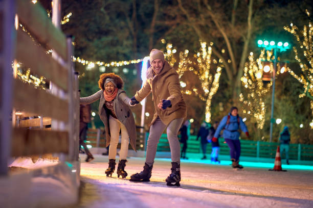 istock Jolly multiethnic couple enjoying ice skating 1360170994