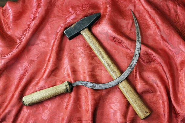 Sickle and hammer on beautiful red shawl Sickle and hammer on rich red shawl as blood left wing politics stock pictures, royalty-free photos & images
