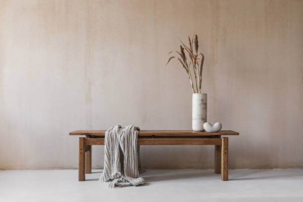 istock Creative composition with elegant wooden bench. Beautiful decorations and accessories. Modern home interior design. Retro inspiration. Copy space. Structure wall. Template.