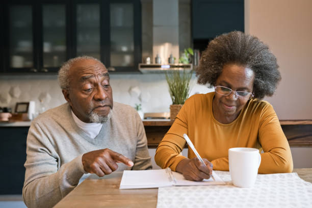 istock Senior couple making to do list 1360171162