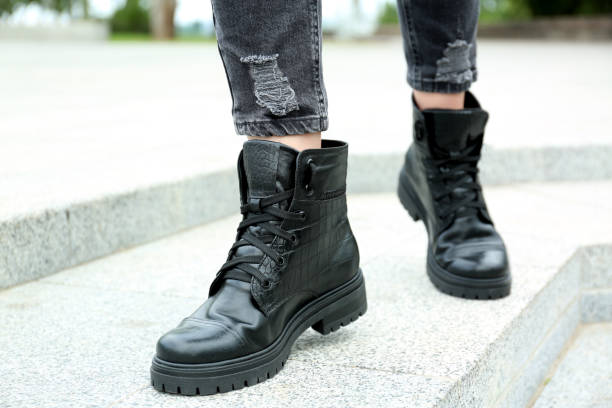 istock Woman wearing comfortable stylish boots outdoors, closeup 1360172332