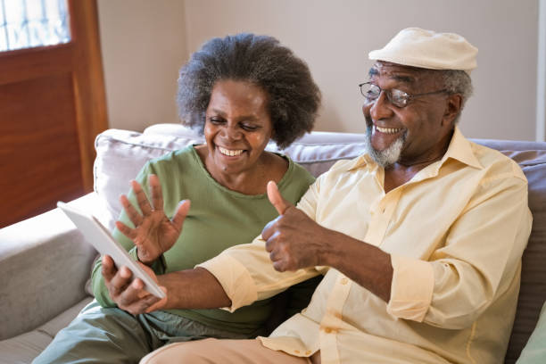 istock Smiling senior couple using dibital tablet 1360172426