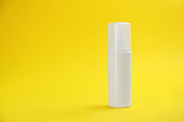 istock Bottle with insect repellent spray on yellow background, space for text 1360172723