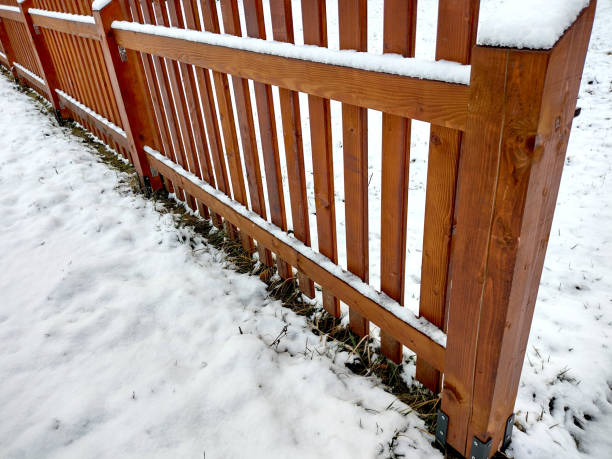 istock snow on a wooden fence 1360174153