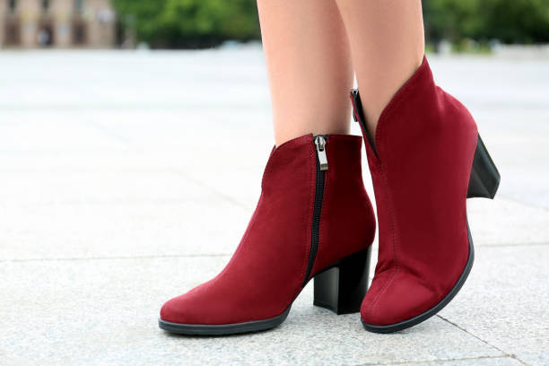 istock Woman wearing comfortable stylish boots outdoors, closeup 1360174749
