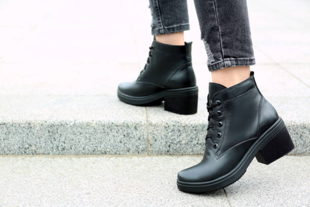 istock Woman wearing comfortable stylish boots outdoors, closeup 1360174751