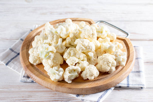 istock Fresh cauliflower on a cutting board on a wooden table 1360180362