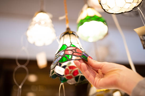 Female hands choosing a lampshade
