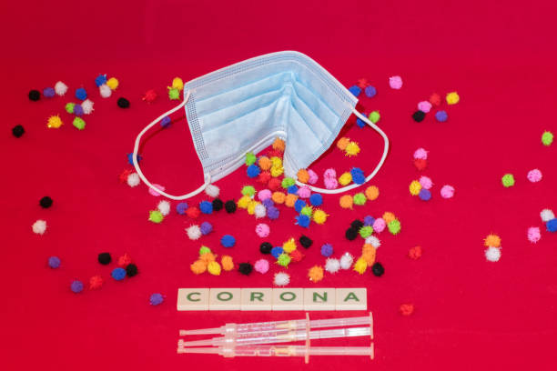 istock Face mask with virus mutations and syringes 1360183409