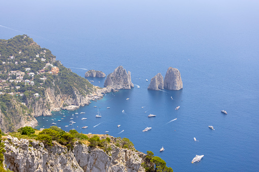 Faraglioni, attractive coastal rock formation eroded by waves, located off the coast of the island of Capri in the Gulf of Naples, Capri, Italy