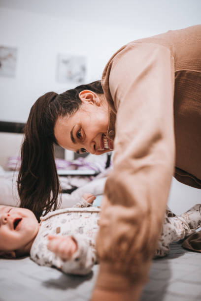 istock Playing with mommy's hair is so fun 1360183975