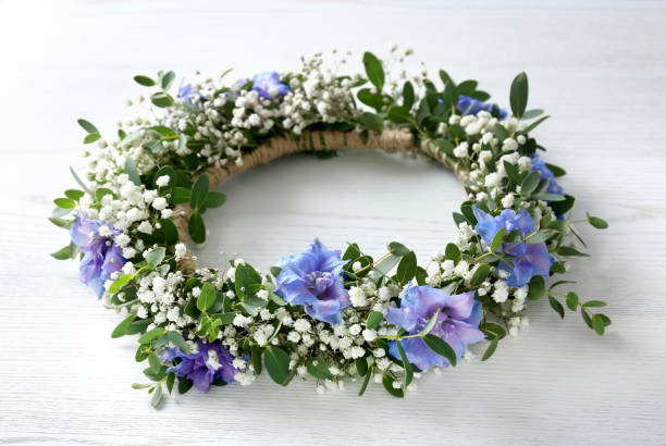 istock Beautiful flower wreath on white wooden background 1360189583
