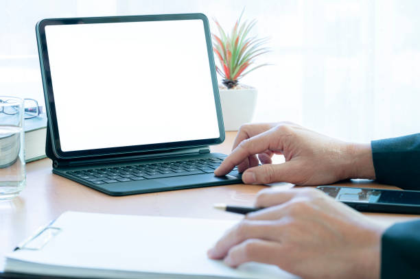 istock Cropped image of businessman hand using portable tablet at office. 1360192718
