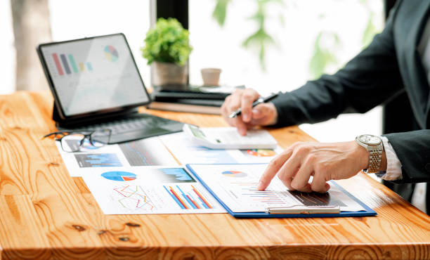 istock businessman working at office with document on his desk, doing planning analyzing the financial report, business plan investment, finance analysis concept.Using calculator and tablet. 1360193556