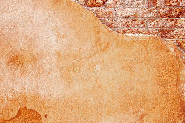 istock Wall background. Old rough stone on cement pattern wall background. Vintage grunge plaster or concrete stucco surface. Art rough stylized texture banner with space for text. 1360193604