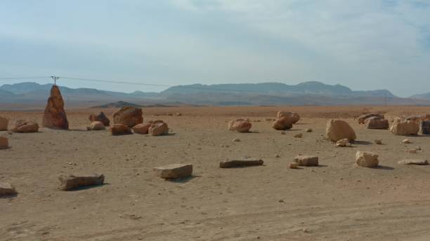 istock Panoramic view of the various structural stone pieces on canyon in desert, mountains covered with fog 1360193634