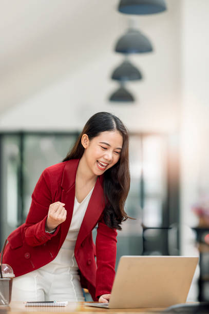 istock Businesswoman celebrating with business successful at work. 1360195191