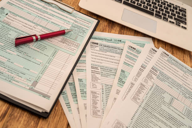 istock US tax forms 1040 ready to fill US citizens with a pen lying on the table 1360195467