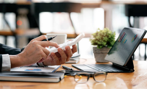 istock businessman working at office with document on his desk, doing planning analyzing the financial report, business plan investment, finance analysis concept.Using calculator and tablet. 1360196488