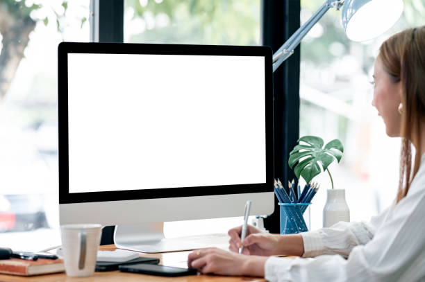 istock woman working on desktop computer at home office. 1360196661