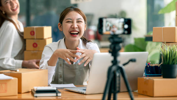 istock Startup small busines SME. Beautiful asian entrepreneur using camera live streaming online chat with her customer. Successful SME business online concept. 1360196701