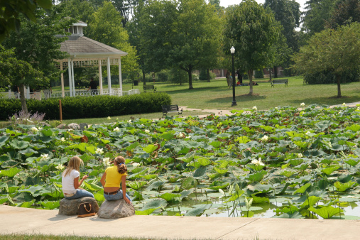 Gazebo and Lily Pond at Goodale Park. Columbus, Ohio. Girls sitting at front left.
