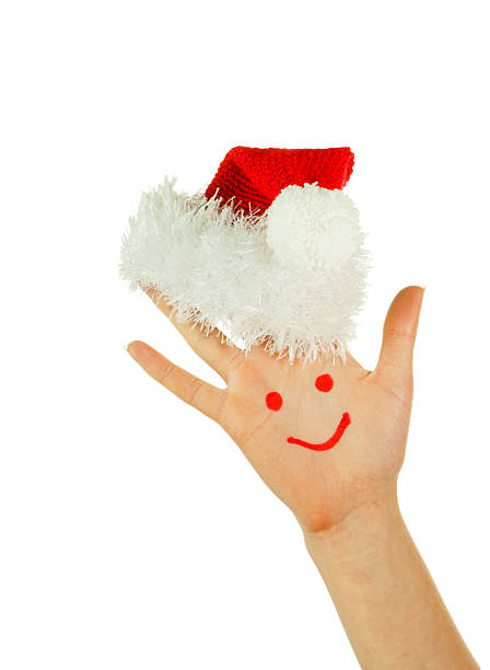 istock Human's palm with smile on it wearing Santa's hat 136019760