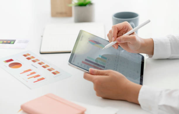istock Cropped shot of hand using portable tablet analyzing business graph. 1360197656
