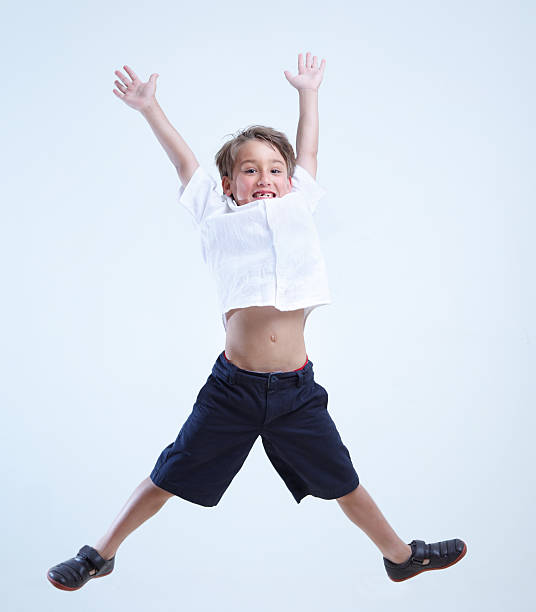 small kid jumping stock photo