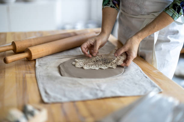 Close-up of craftswoman working on her pottery in workshop
