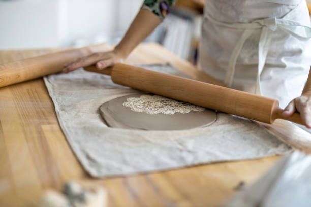 istock Close-up of craftswoman working on her pottery in workshop 1360200159