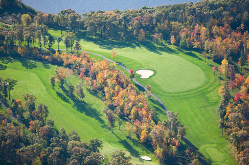 Aerial view of golf course and lake during the fall
