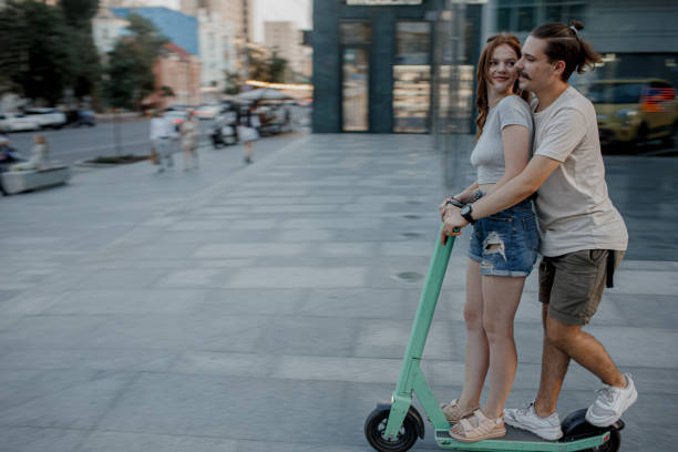 istock Couple is having fun driving electric scooters on a sunny day. 1360200245