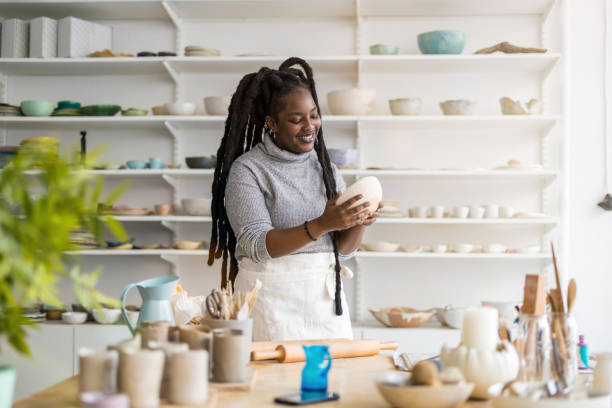 Woman pottery artist working in her art studio