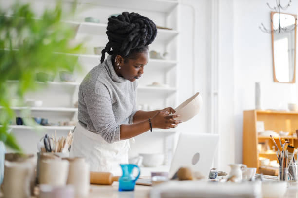 istock Woman pottery artist working in her art studio 1360200403