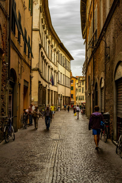 Street in the historic center of Lucca, Italy People walking on a street in the historic center of Lucca, Tuscany, Italy lucca italy stock pictures, royalty-free photos & images