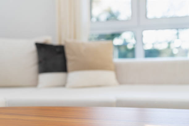 istock Empty wooden Table Top with white sofa in modern living Room 1360201350