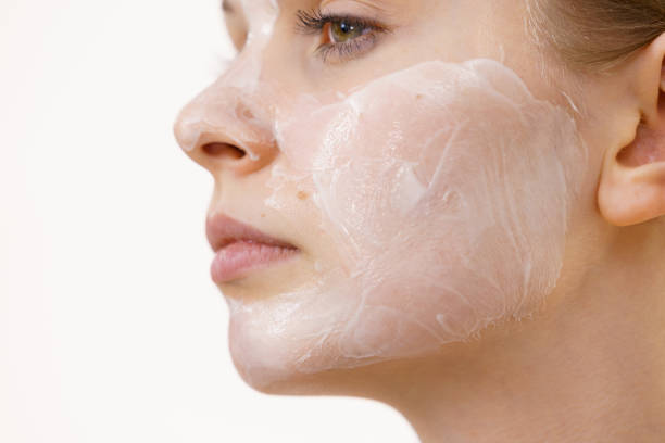 istock Girl with cream moisture cosmetic on face 1360202825