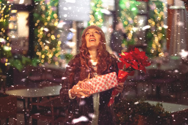 istock Cheerful woman is outdoors at Christmas holidays time 1360202855
