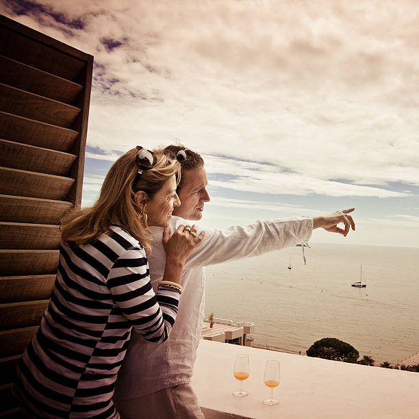 middle age couple looking at the sea stock photo